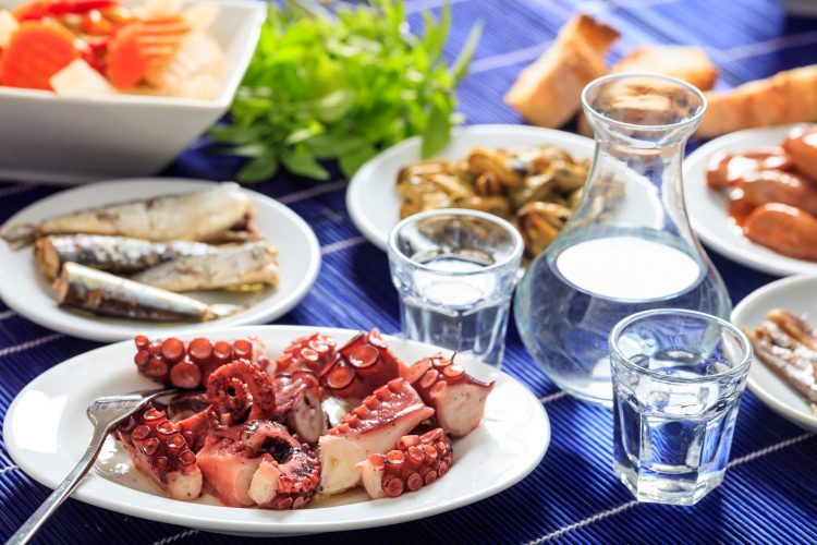 Glasses of ouzo and appetizers